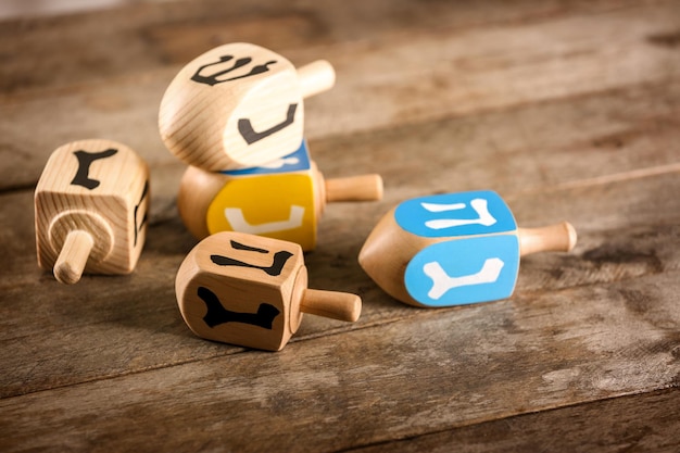 Composition of dreidels for Hanukkah on wooden table