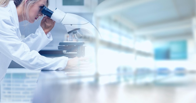 Photo composition of female lab technician using microscope, with blurred copy space to right