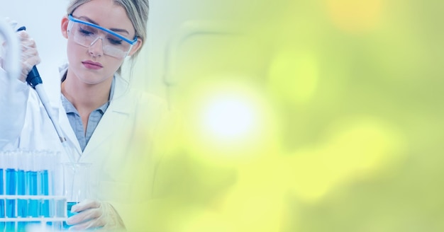 Composition of female lab technician using pipette, with yellow blurred copy space to right