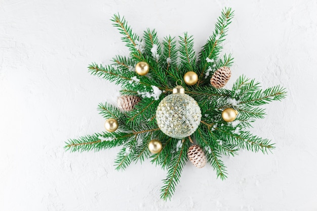 Composition of fir branches Christmas balls and cones on a light background Christmas and New Year