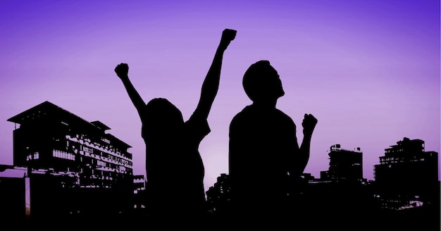 Photo composition of fit male and female silhouettes raising hands over cityscape