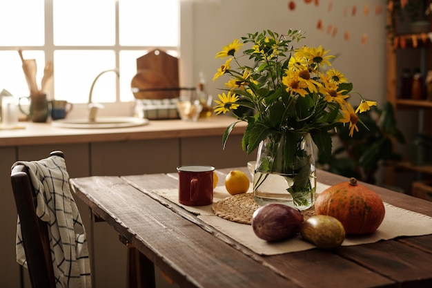 Composition of fresh wildflowers in vase or jar standing on wooden table