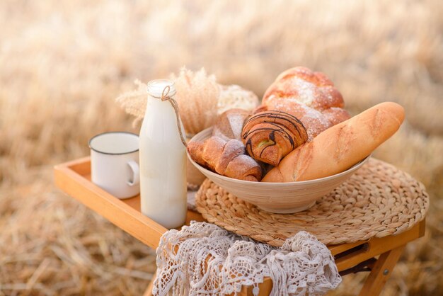 Composition from an assortment of fresh bread on a mowed field of wheat.