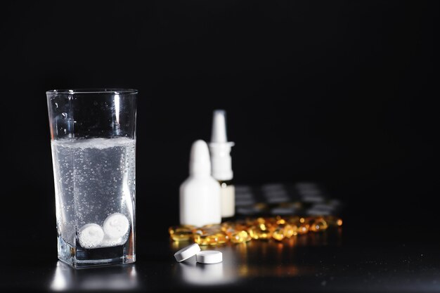 Composition from Bottles of cough syrup.Healthcare, medicine, flu and treatment concept - paper wipes and thermometer with pills.