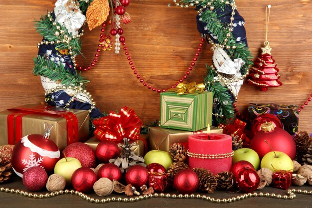 Composition from Christmas decorations on wooden table on wooden background