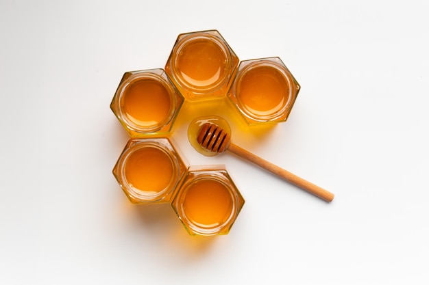 Composition from different jars with honey on isolation