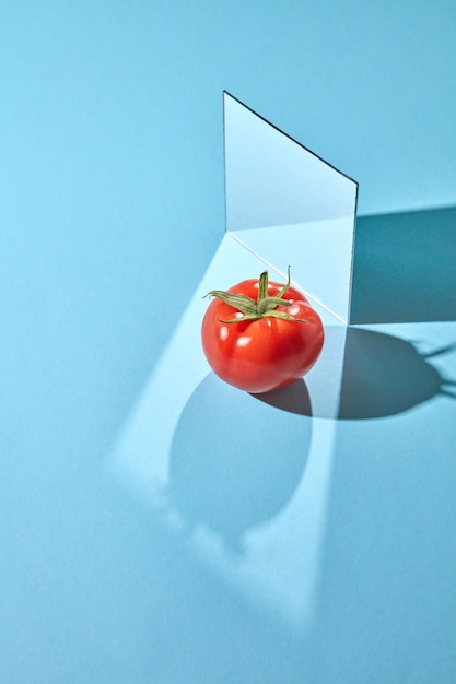 Composition from a mirror and a ripe tomato