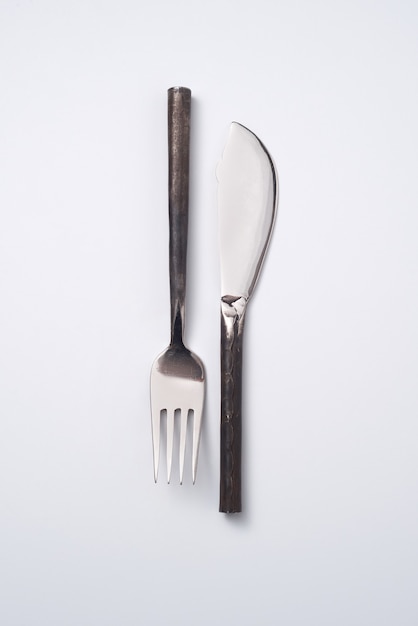 Composition from vintage metal fork and knife on a gray background with space for text. Flat lay