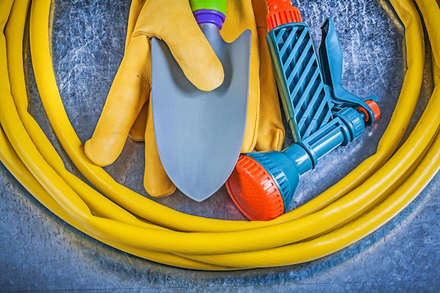 Composition of gardening tools on scratched metallic background agriculture concept