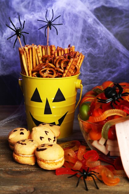 Photo composition for halloween with sweets on wooden table