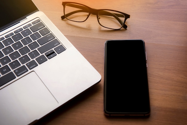 Composition of laptop, glasses and mobile phone