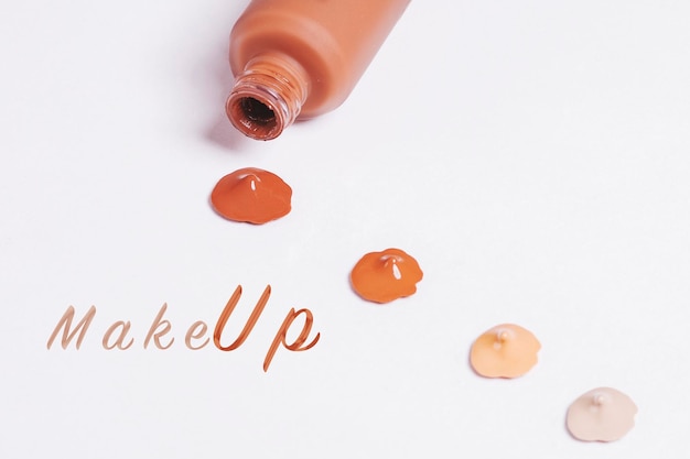 Composition of makeup drops in various shades isolated on a white background