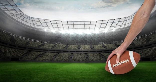 Photo composition of male rugby player holding rugby ball over sports stadium