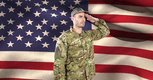 Composition of male soldier saluting over american flag