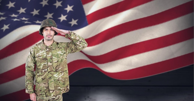 Composition of male soldier saluting over american flag