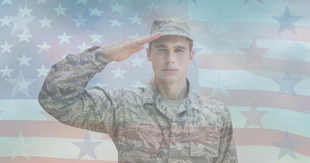 Composition of male soldier saluting over american flag