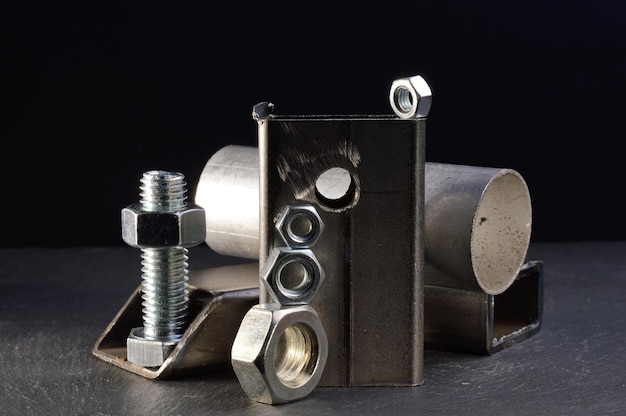 Composition of nuts bolts and scraps of metal laid out on a dark backgroundxA