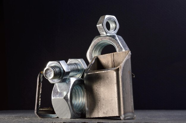 Composition of nuts bolts and scraps of metal laid out on a dark backgroundxA