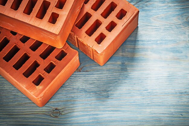 Composition of orange bricks on wooden board construction concept.