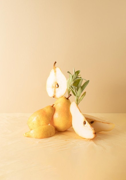 composition of pears and sprigs of sage on a beige background Creative fruit food concept