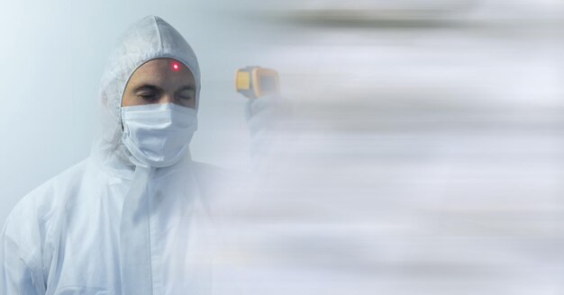 Composition of person wearing ppe suit and mask, with blurred copy space