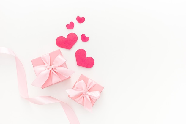 Composition of pink two gift boxes with ribbon and hearts