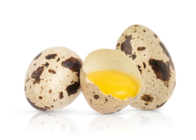 Composition of quail eggs with broken one isolated on white background