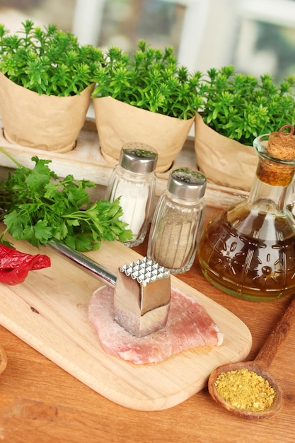 Composition of raw meat vegetables and spices on wooden table closeup