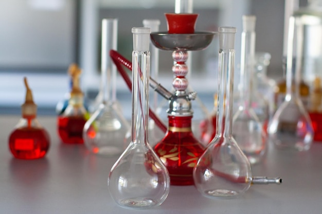 Composition of red hookah and chemical glass flasks