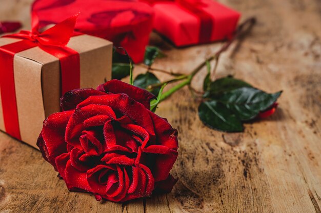 Composition of red roses and gift boxes