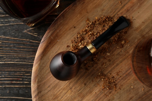 Composition of relaxation with smoking tobacco with smoking pipe on wooden table