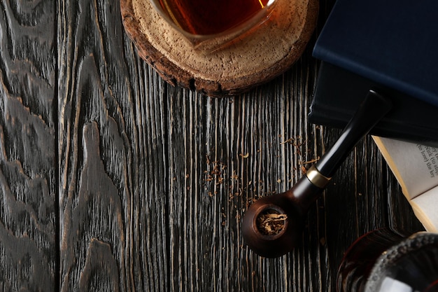 Composition of relaxation with smoking tobacco with smoking pipe on wooden table