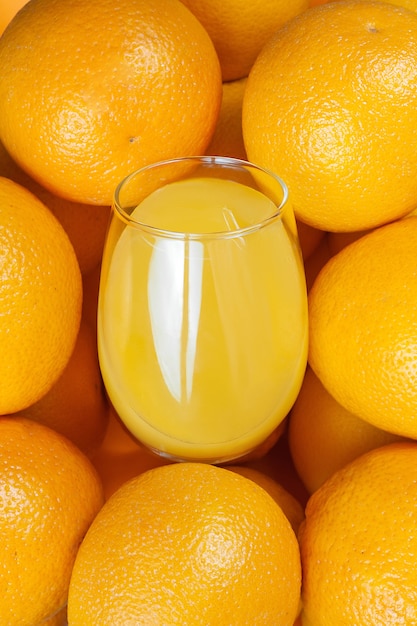 Photo composition of ripe oranges and glass glass glass of orange juice. . high quality photo