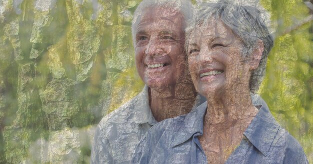 Composition of senior couple embracing, smiling and autumn foliage