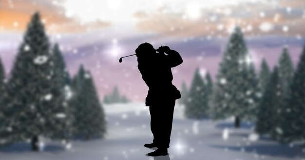 Composition of silhouette of santa claus playing golf over\
winter landscape