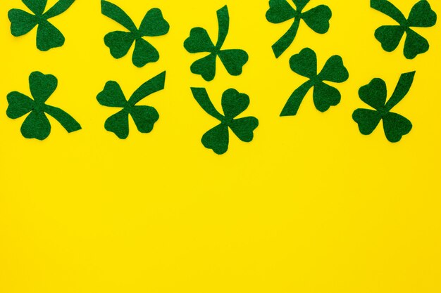 Photo composition for st. patrick's day. decorating paper with green clover or shamrocks and gold coins