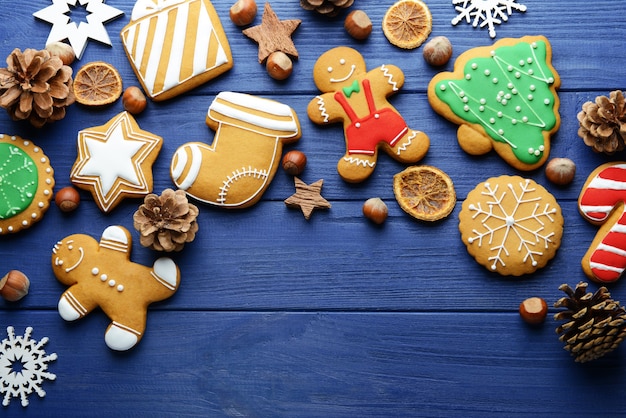 Composition of tasty Christmas cookies and natural decor on wooden table