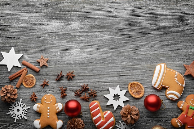 Composition of tasty cookies and Christmas decor on wooden table