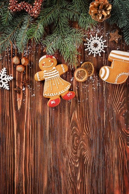 Foto composizione di gustosi biscotti di pan di zenzero e decorazioni natalizie su fondo di legno