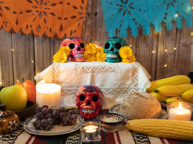 Composition of traditional altar for Mexican day of the dead with skull candles offering and flowers