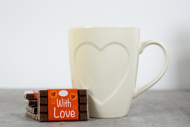Composition for Valentine's Day with a cup of coffee and a gift box on the table Holiday concept