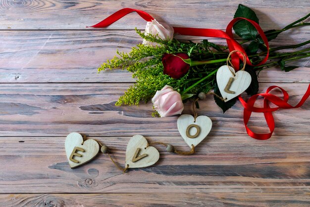 Composition for Valentine's Day, Women's Day or birthday. Romantic bouquet of gentle roses on a wooden table close-up.