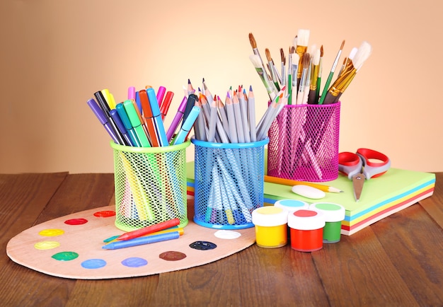 Composition of various creative tools on table on beige