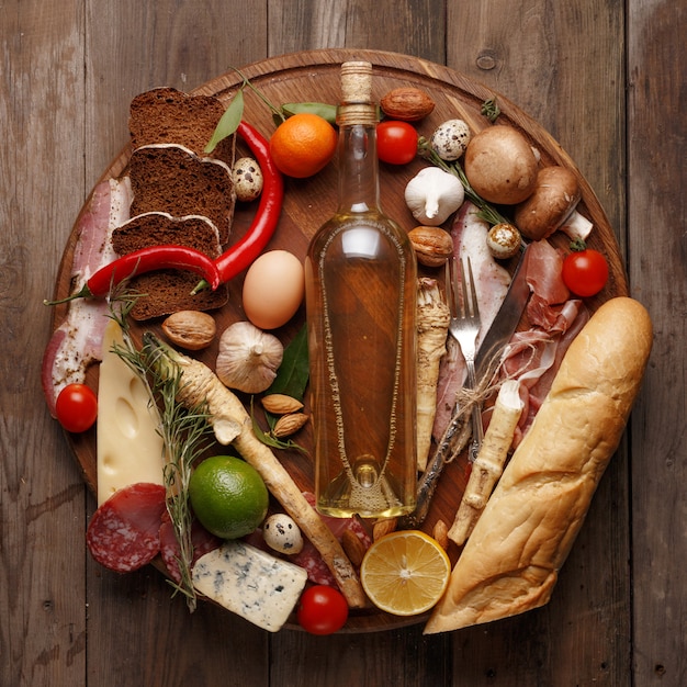 Composition of various foodstuffs on a wooden table. Top view.