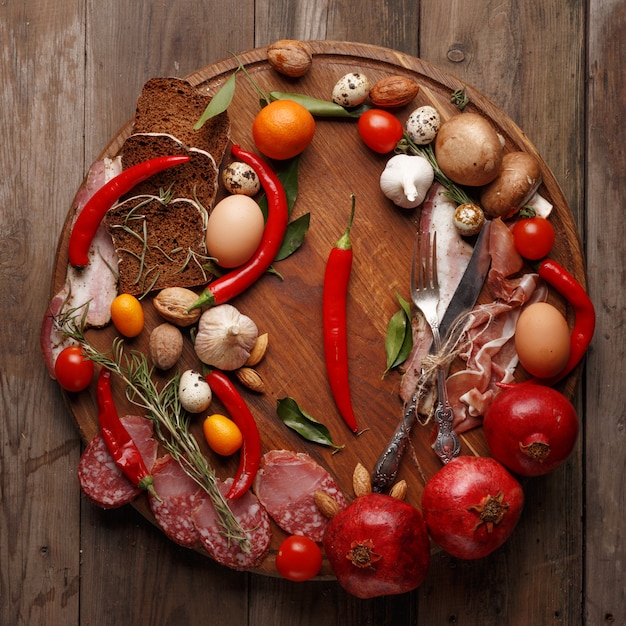 Composition of various foodstuffs on a wooden table. Top view.