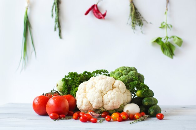Composition of various fresh vegetables on a wooden table