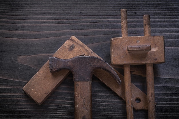 Composition of vintage wooden claw hammer square ruler and marking gage