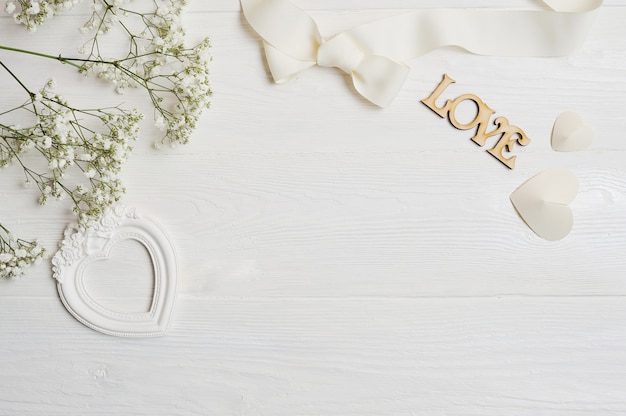 Photo composition of white flowers rustic style, hearts love and a gift