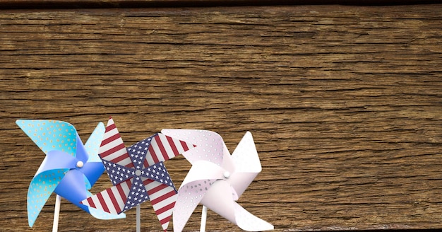 Composition of windmills coloured with american flag over wooden table