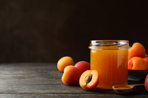 Composition with apricots and jam on wooden